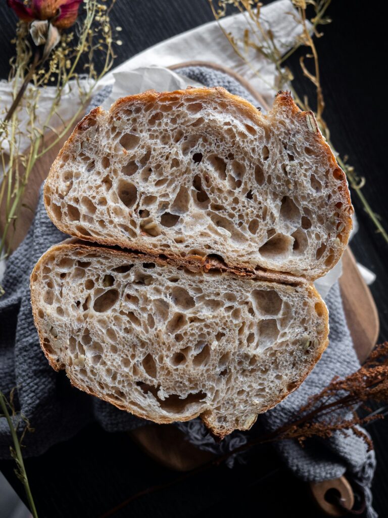 Sourdough bread cut in half with lots of air pockets that indicate fermentation