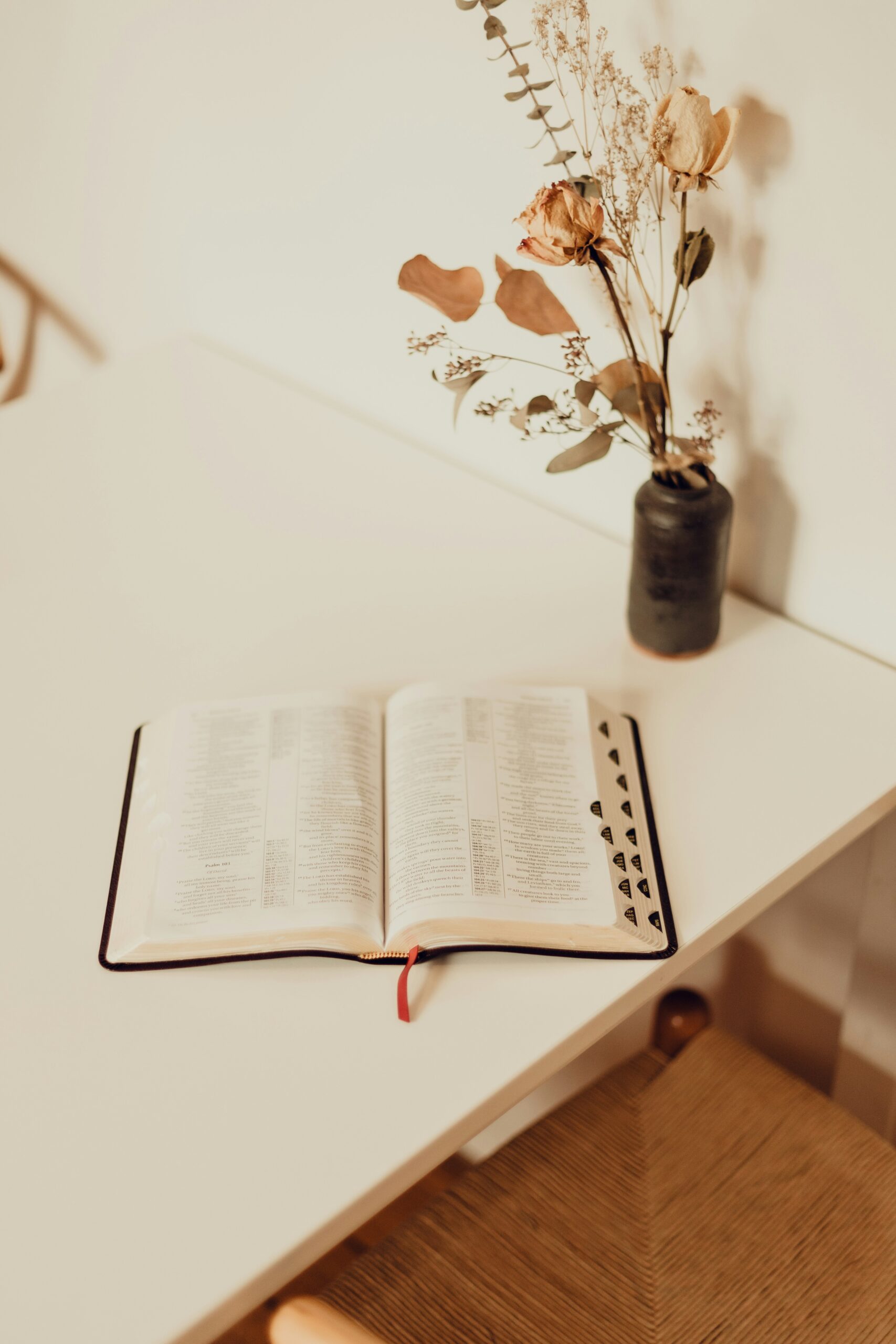 best Bible study tools for absolute beginners, open bible on desk with flowers